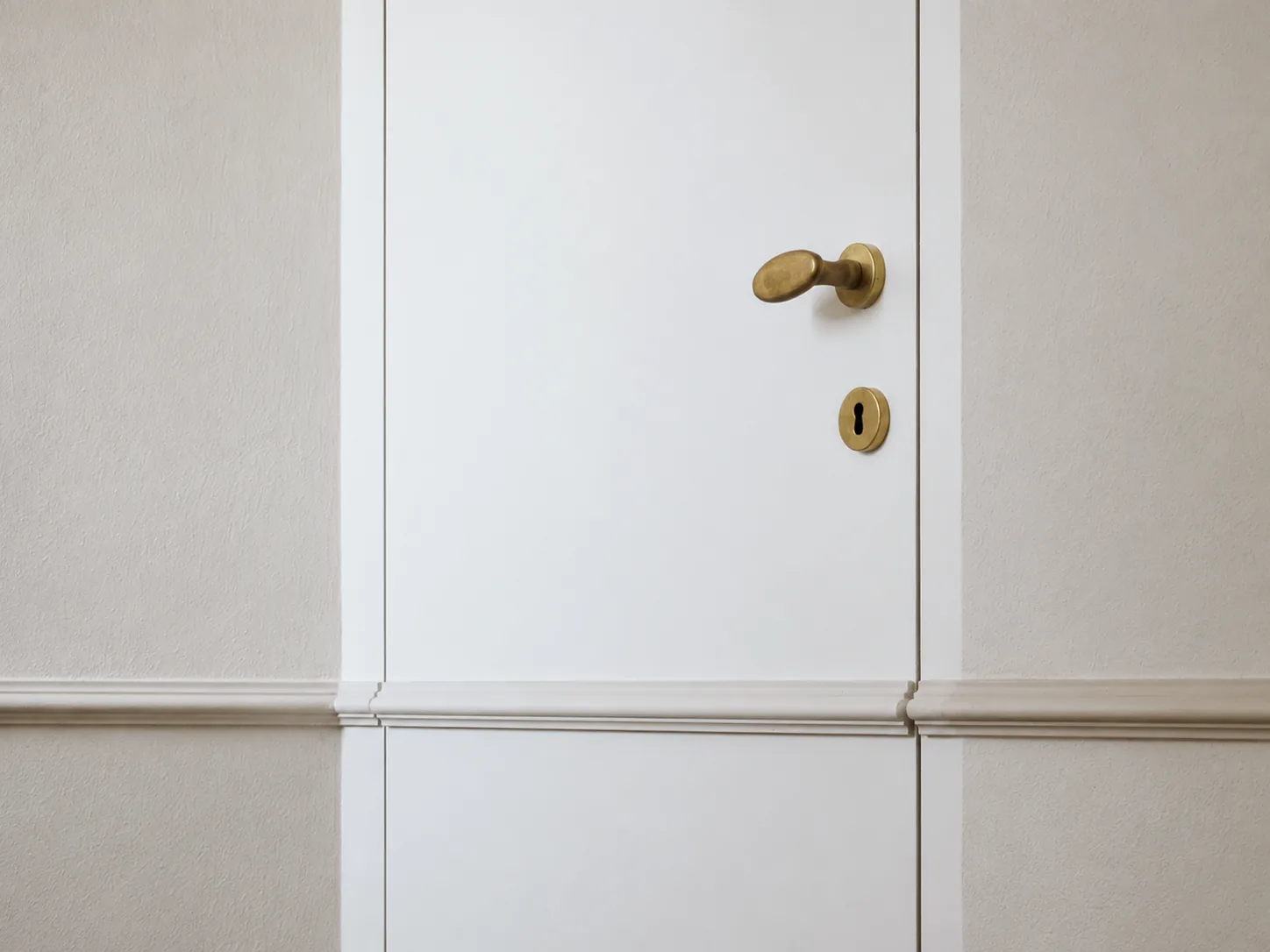Flush joinery, brass knob and wall panelling