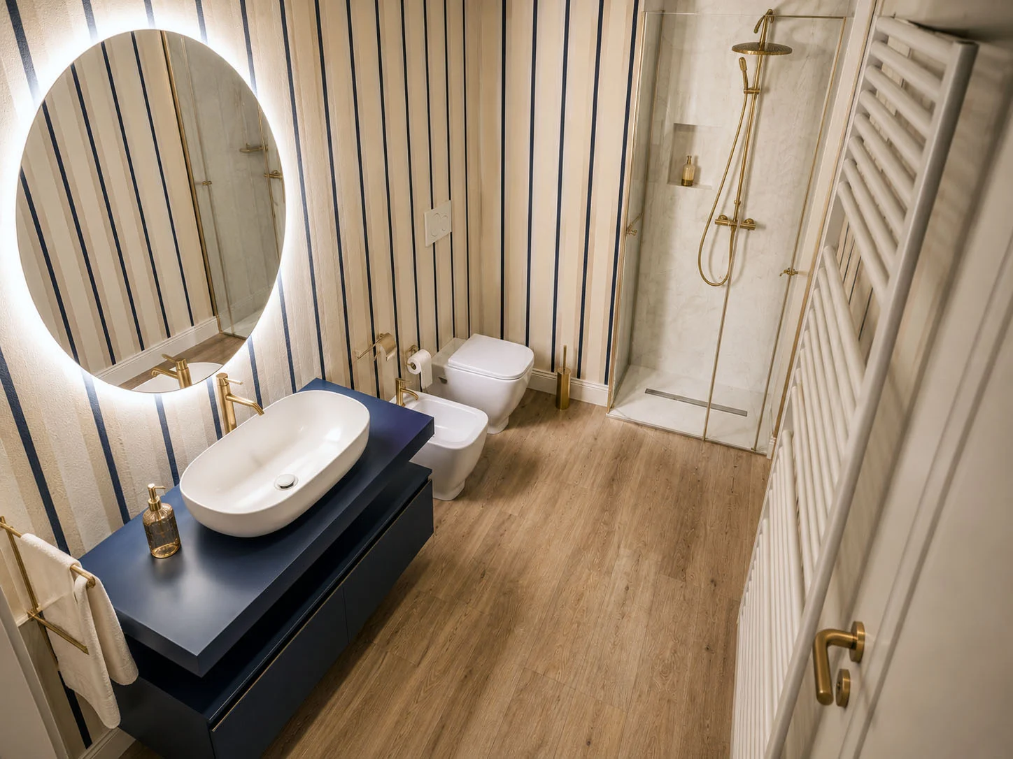 Blue-striped en-suite bathroom with brass fittings