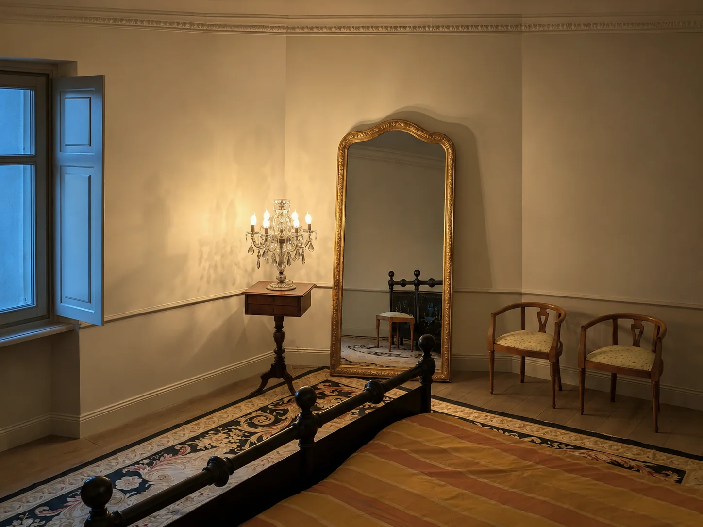 Bedroom with painted antique bed and tall gilt mirror