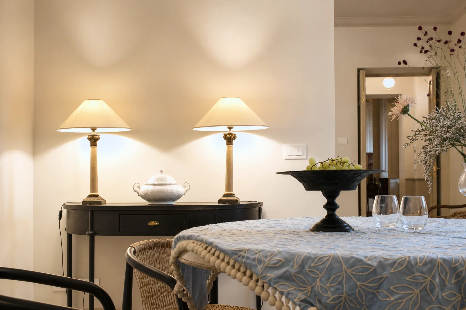 Laid table beneath a pair of pendant lamps