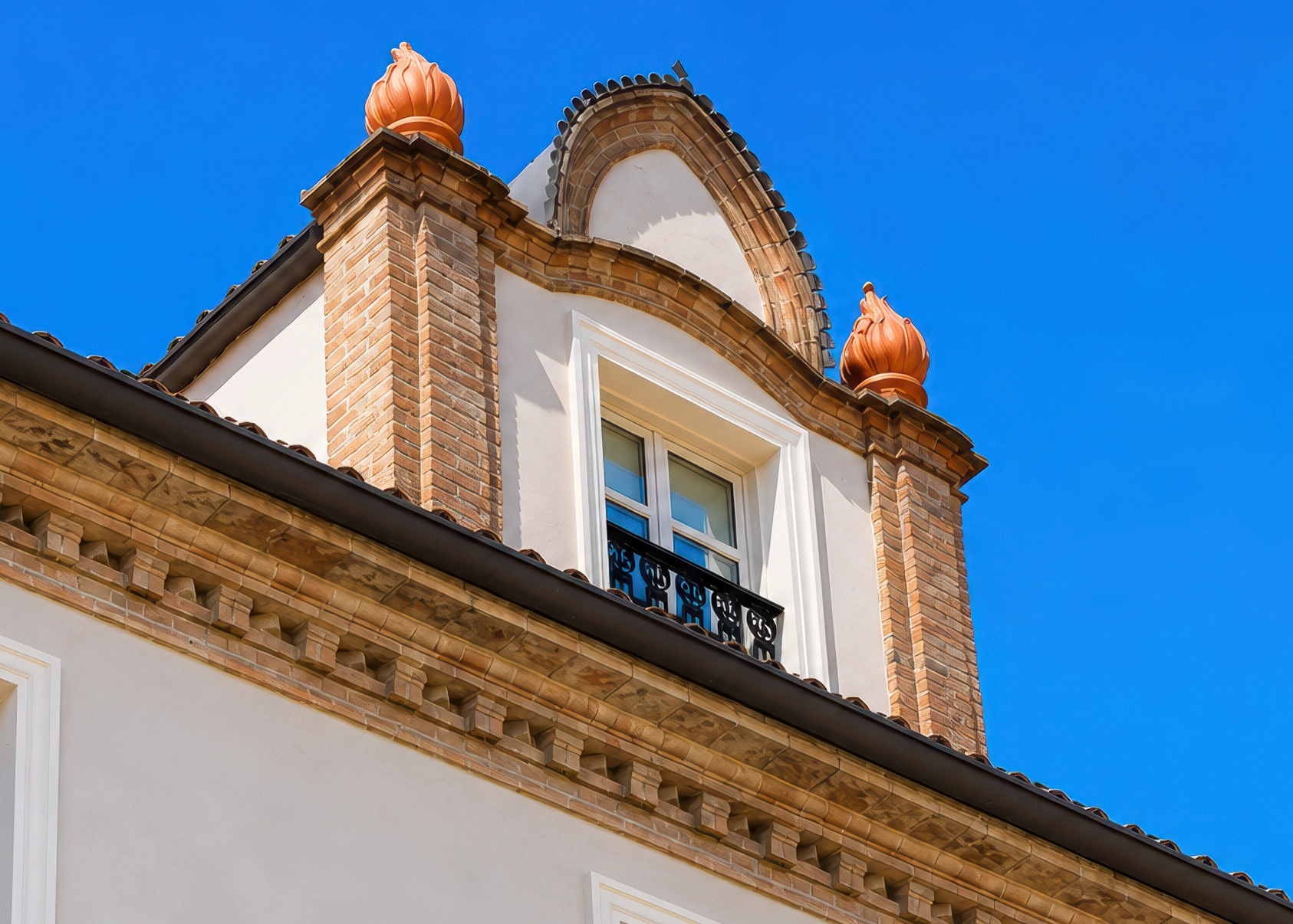 Cornice, dormer and balcony on the restored façade